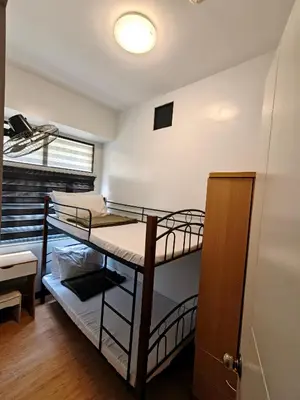 a dorm room with two bunk beds in it at Fully-furnished 2BR Condo in Pasig, Cainta in Cainta
