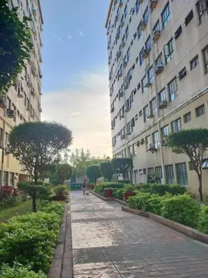 a walkway between two tall buildings in a city at Fully-furnished 2BR Condo in Pasig, Cainta in Cainta