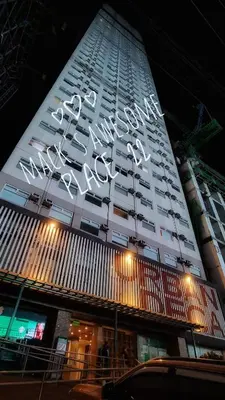 a tall white building with a sign on it at Macks Awesome 07 Fast Wifi Premium Netflix in Manila