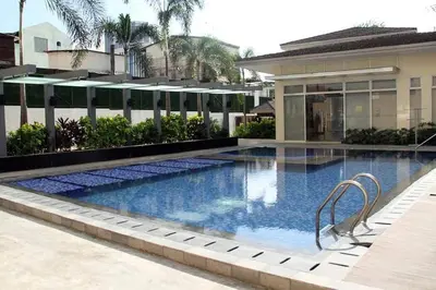 a swimming pool in front of a building at 2BR Fully furnished Condo in Makati, Mandaluyong in Manila