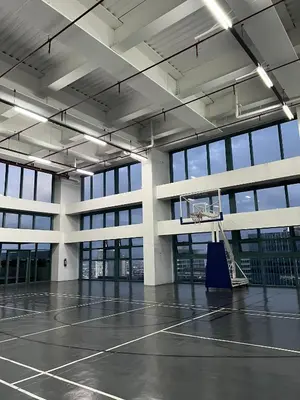 an empty gym with a basketball hoop in a building at Affordable One Bedroom at One Uptown, BGC Manila in Manila