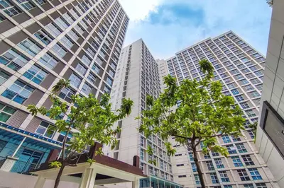 a view of tall buildings in a city with trees at Japanese Stylish Condo in Makati in Manila
