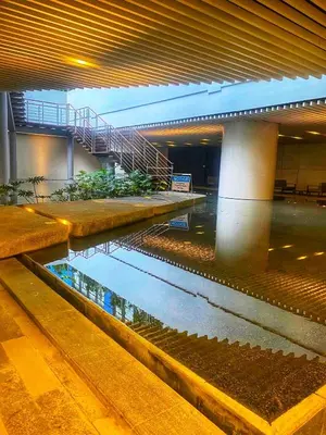 a building with a pond in the middle of a building at Air Residence 1BR Condo with City View in Manila