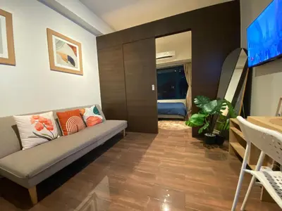 a living room with a couch and a television at Air Residence 1BR Condo with City View in Manila