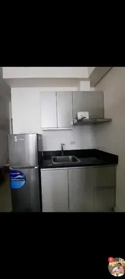 a kitchen with a sink and a refrigerator at THE BEACON Aparthotels in Manila
