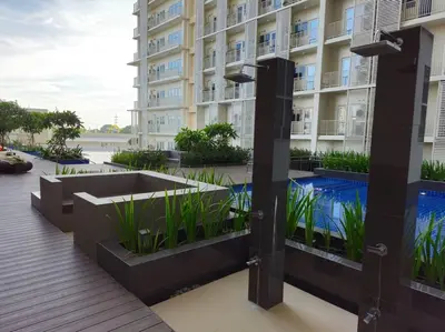 a large building with a swimming pool in front of it at Modern & New, Work Desk, Fast Internet, Balcony in Manila