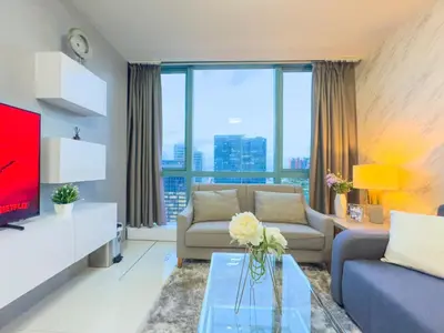 a living room with a couch and a tv at 1BR BGC, One Uptown Residence B001 in Manila