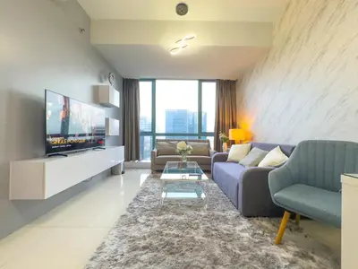 a living room with a couch and a tv at 1BR BGC, One Uptown Residence B001 in Manila