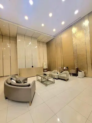a lobby with couches and tables in a building at Bigg Apol Suite in Manila