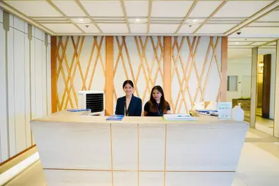 two women sitting at a counter in an office at NEW! Studio Condo in Prisma Residences Pasig in Manila