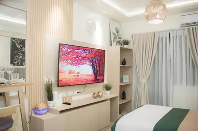 a bedroom with a flat screen tv on a wall at Becca Suite by Crib2GO with Pool View in Manila