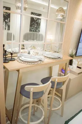 a dining table with two chairs and a mirror at Becca Suite by Crib2GO with Pool View in Manila
