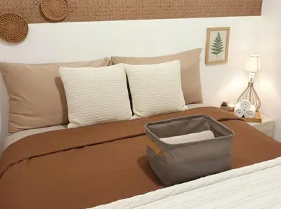 a bedroom with a bed with a suitcase on it at Ortigas CBD Greenfield Residences in Manila