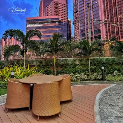 a patio with a table and chairs in a city at Homefort at Lush Residences Makati Unit 1137 in Manila