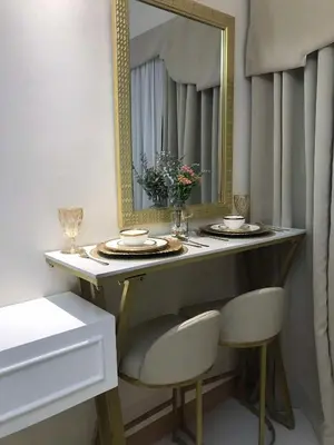 a dressing table with two chairs and a mirror at Homefort at Lush Residences Makati Unit 1137 in Manila