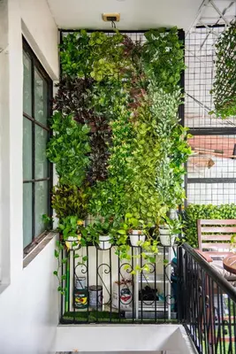 a wall with potted plants on a balcony at Homey and Cozey Poblacion Makati S03 in Manila