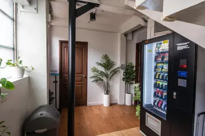 a room with a soda vending machine and a door at Homey and Cozey Poblacion Makati S06 in Manila