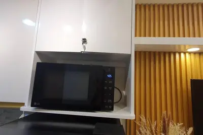 a microwave oven on a shelf in a kitchen at Red Residence Makati-Cozy Condo Unit with Balcony in Manila