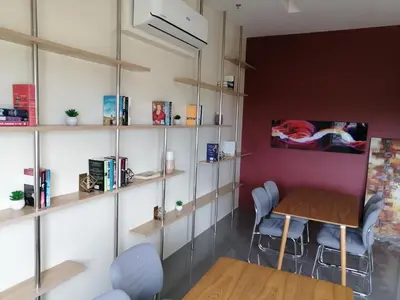 a room with shelves and a table and chairs at Homey Staycation in Silang Cavite! Fullerton Suites Puting Kahoy - near CKS, AUP, PNPA, in Puting Kahoy