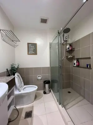 a bathroom with a shower and a toilet and a sink at Kapitolyo Prisma Residential Condo TCPH21 - NYC Vibes Penthouse with KTV Pool and Balcony with City View Panorama 5 Min Drive to BGC St Lukes and Ortigas - Staycations by SMS in Manila
