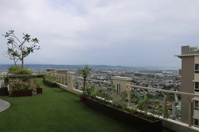 a balcony with a view of a city at Kapitolyo Prisma Residential Condo TCPH21 - NYC Vibes Penthouse with KTV Pool and Balcony with City View Panorama 5 Min Drive to BGC St Lukes and Ortigas - Staycations by SMS in Manila