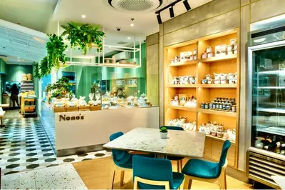 a restaurant with a table and chairs in a store at Best Value Stylish Loft Steps from Greenbelt Mall in Manila