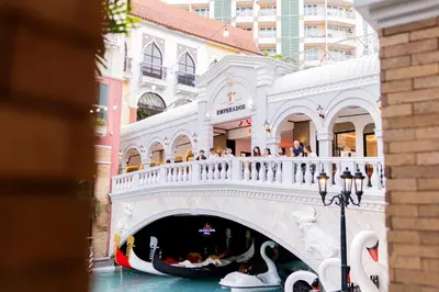 a gondola in a canal in front of a building at LUXX BGC Venice in Manila