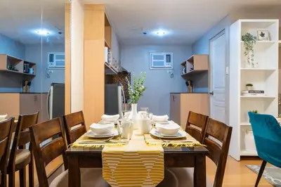 a dining room with a table and chairs in a kitchen at Avant at the Fort BGC 1BR Flr to Ceiling Cor Unit with Great View in Manila