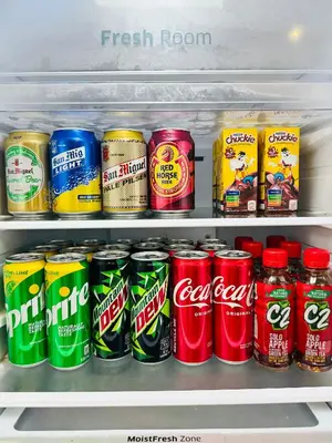 a refrigerator filled with lots of cans of soda at Azure Staycation by Via Sabby in Manila