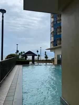 a swimming pool in front of a building at Condo In front of US Embassy Studio Unit with 2 Double Beds in Manila