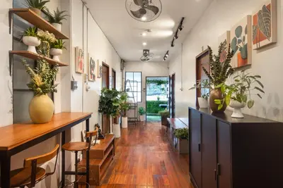 a hallway with a table and chairs and plants at Homey and Cozey Poblacion Makati S07 in Manila