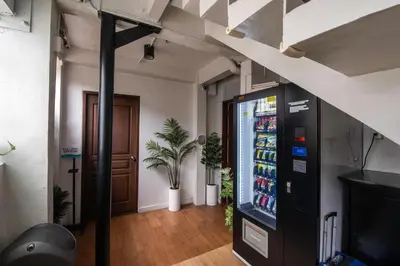 a drink vending machine in a room with a door at Homey and Cozey Poblacion Makati S07 in Manila