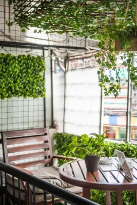 a table with a potted plant on a patio at Homey and Cozey Poblacion Makati S08 in Manila