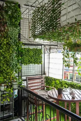 a balcony with a table and chairs and plants at Homey and Cozey Poblacion Makati S08 in Manila
