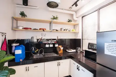 a kitchen with a sink and a refrigerator at Homey and Cozey Poblacion Makati S09 in Manila