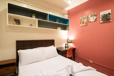 a bedroom with a bed and a red wall at Homey and Cozey Poblacion Makati S10 in Manila