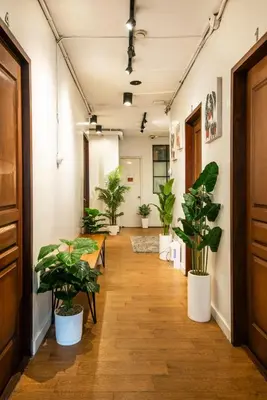 a corridor with potted plants in an office at Homey and Cozey Poblacion Makati S11 in Manila