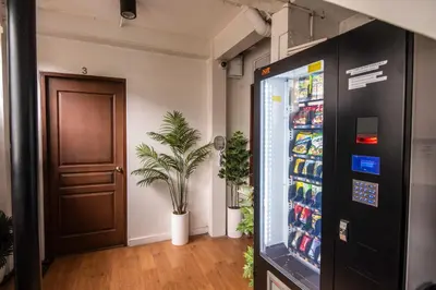 an office with a soda vending machine and a door at Homey and Cozey Poblacion Makati S12 in Manila