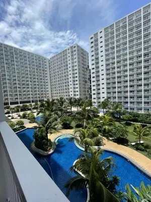 a view of a resort with a pool and palm trees at Santa Place Shore Residences Tower A in Manila