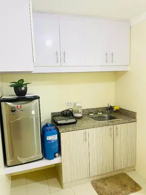 a kitchen with a sink and a counter top at DJ Apartment in Manila