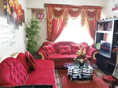 a living room with red couches and a window at Sweetheart Casa Vacanza in Manila