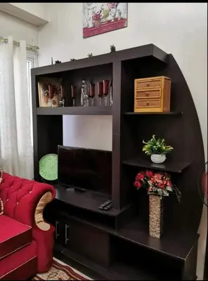 a living room with a red couch and a black book shelf at Sweetheart Casa Vacanza in Manila