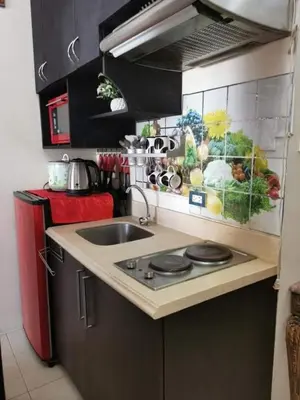 a small kitchen with a sink and a stove at Sweetheart Casa Vacanza in Manila