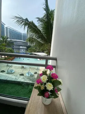 a vase of flowers sitting on a table on a balcony at Cozy Inn Azure in Manila