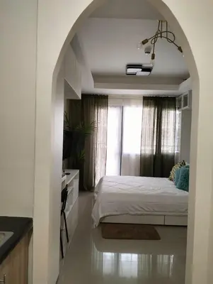 a bedroom with a white bed and a window at Shore 2 Residences by Casa Stellar in Manila