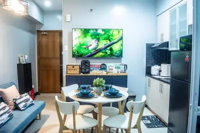 a kitchen and dining room with a table and chairs at Elivion Staycations at McKinley Hill, near Venice, BGC, with Pool & Wifi in Manila