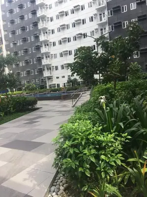 a walkway in front of a large apartment building at A & Y Staycation in Manila