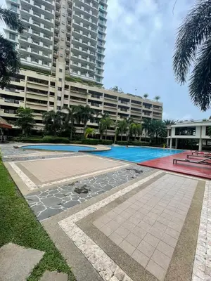 an empty swimming pool in front of a large building at Luxury Bauhaus inspired apartment near Makati in Manila