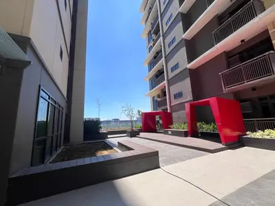 a view of a building with red furniture in a courtyard at GENTRY MANOR fast WiFi,Balcony near Okada,MOA&NAIA 8Q in Manila