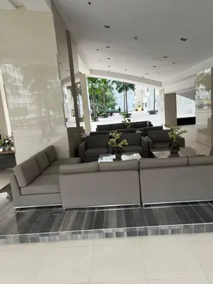a living room with couches in a building at Budget SHORE Family Suite 2 Bed WiFi Netflix MOA844 in Manila